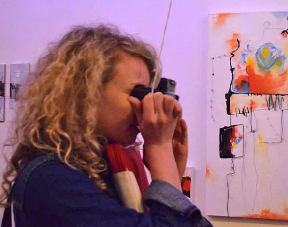 Looking through a Viewer at an art exhibition